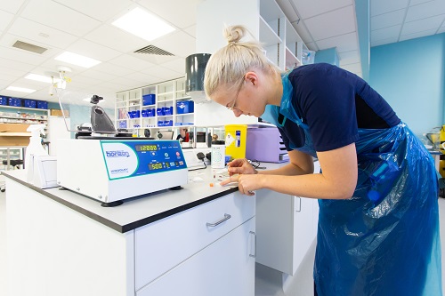 A person working in a lab with equipment.